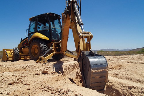 A construction Back Hoe digging the footings for a foundation.